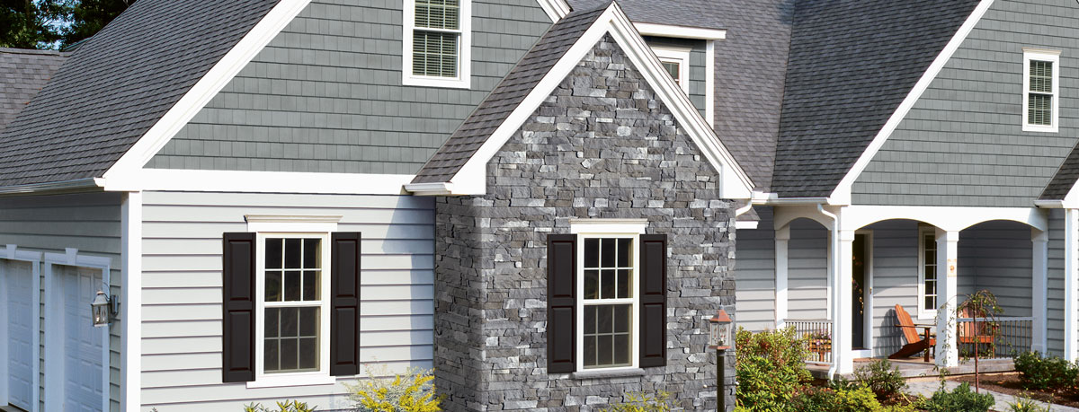 Home Exterior Black Stacked Stone And Blue Siding